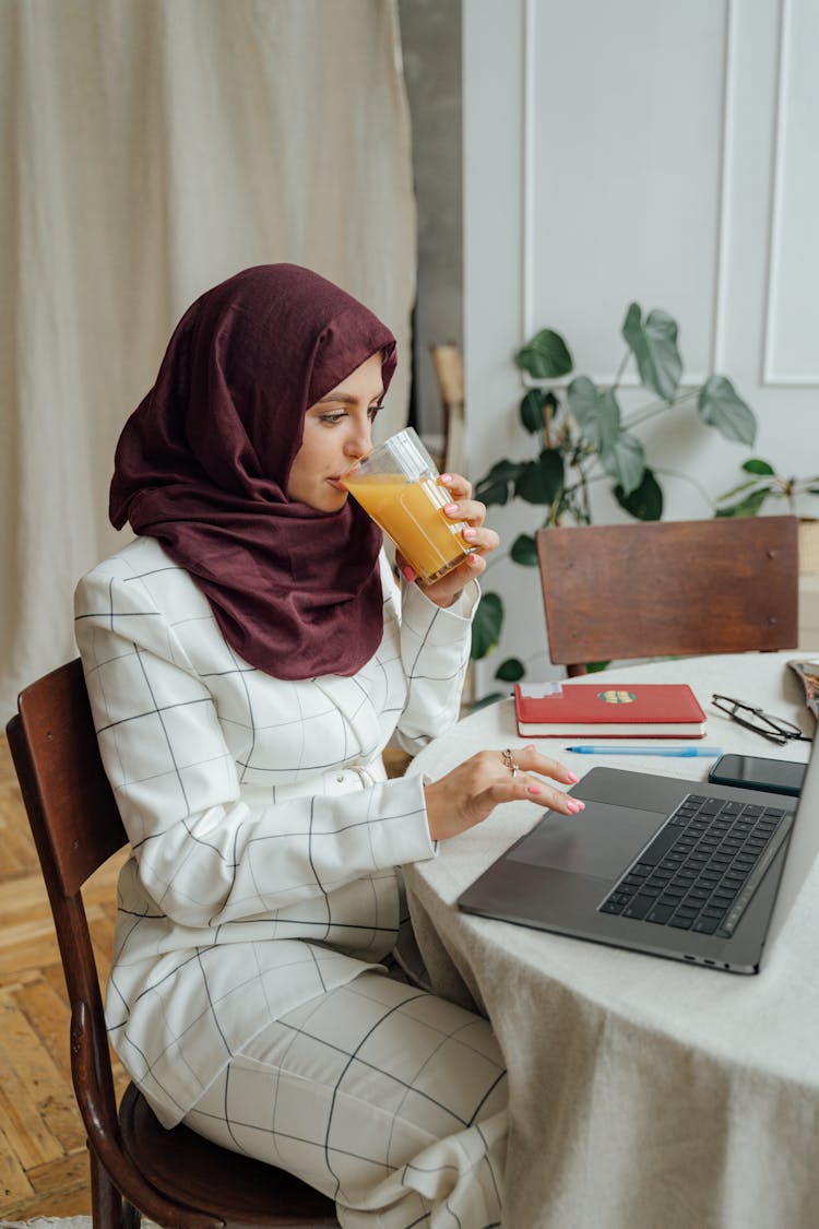 Woman In A Hijab Using A Laptop