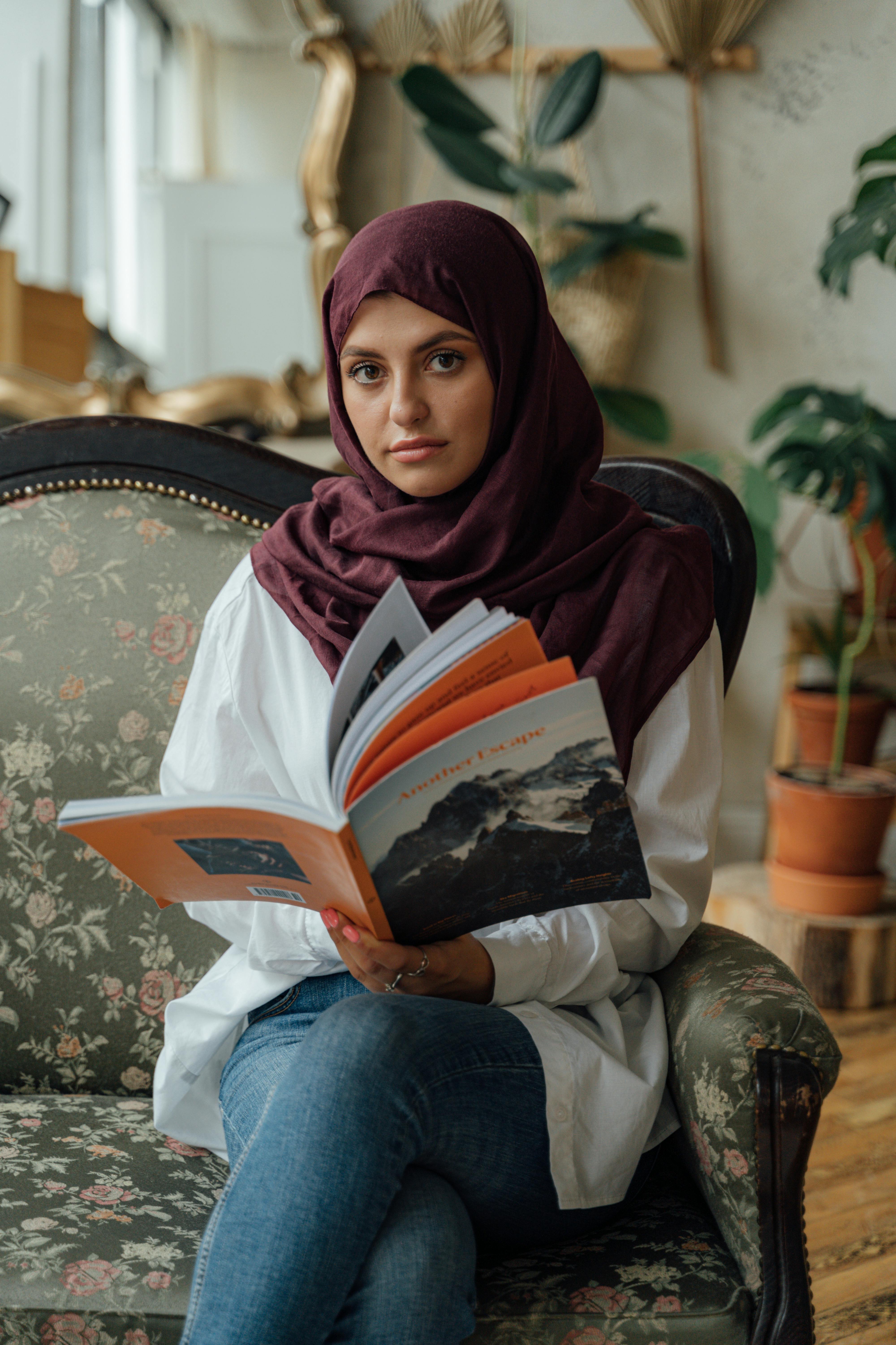 Image Of Smiling Young Woman Posing Isolated Over Pink Background Wall Holding  Book Reading. Stock Photo, Picture and Royalty Free Image. Image 125427033.