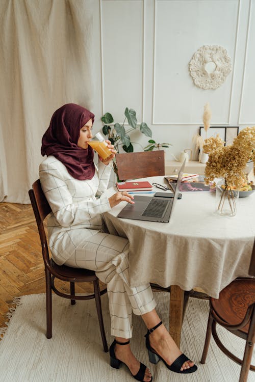 Woman in a Hijab Using a Laptop