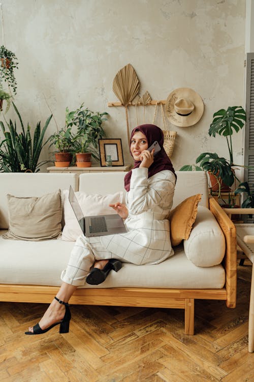 Woman in a Hijab Using a Laptop