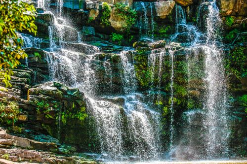 Free Stunning waterfall cascading over rocks in Durban's lush green park, South Africa. Stock Photo