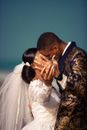 Side view of loving newlywed African American couple kissing gently and demonstrating ring on finger of groom at wedding ceremony