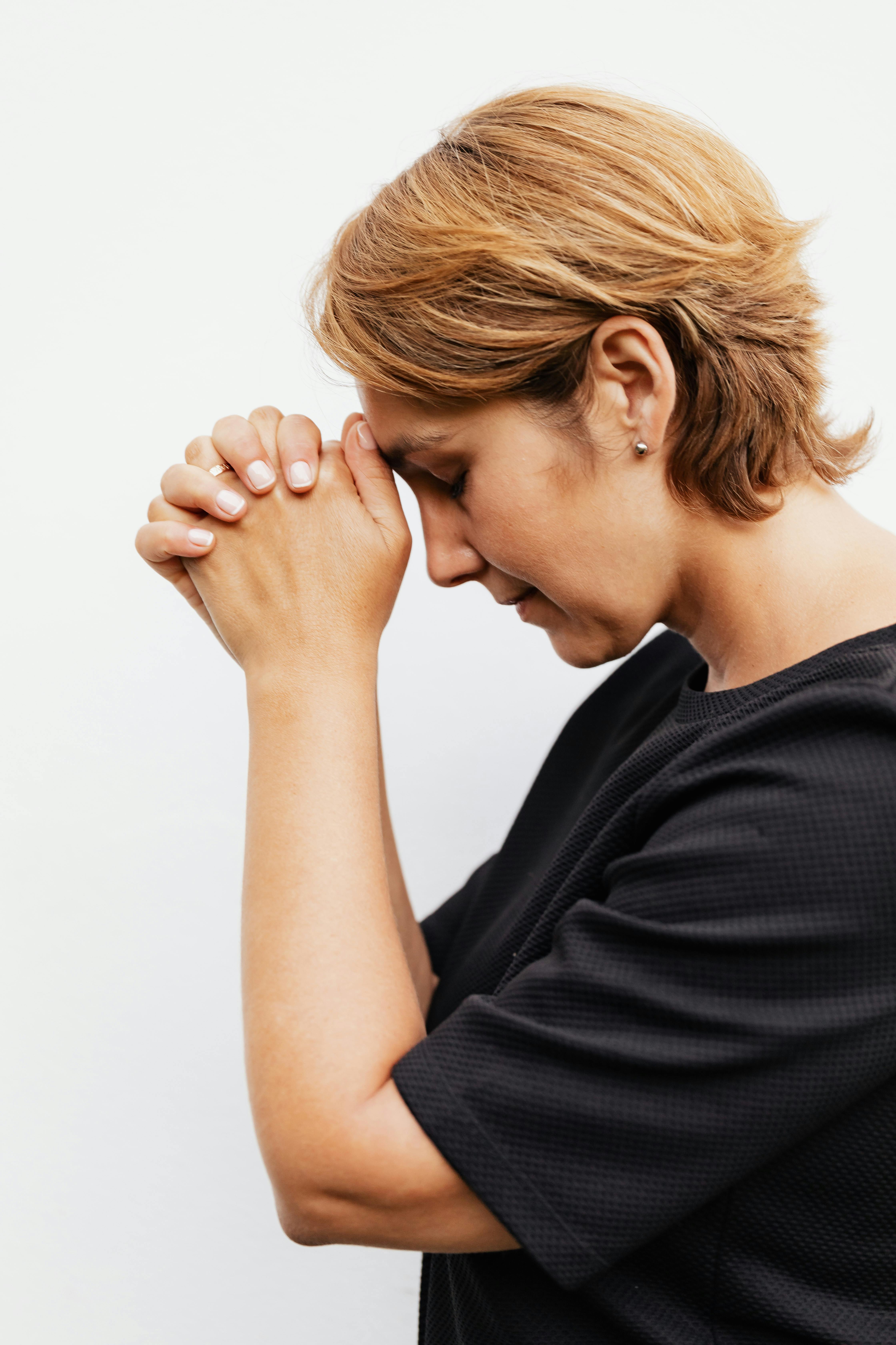 close up shot of a woman in black shirt praying