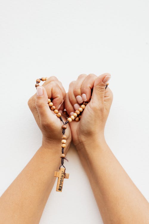 Close-Up Shot of a Person Holding a Rosary