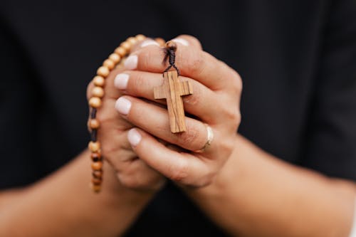 Close-Up Shot of a Person Holding a Rosary