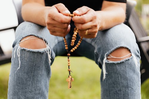 Close-Up Shot of a Person Holding a Rosary