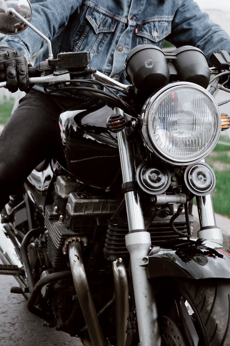 A Person Riding A Black Motorcycle