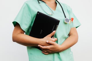 
A Doctor Holding a Digital Tablet