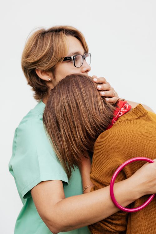 Free A doctor comforts a patient in a supportive embrace, emphasizing emotional care. Stock Photo