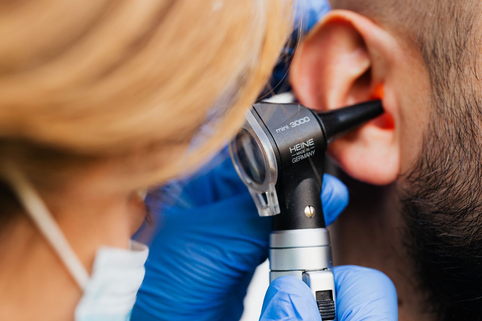 Medical professional examining a patient's ear