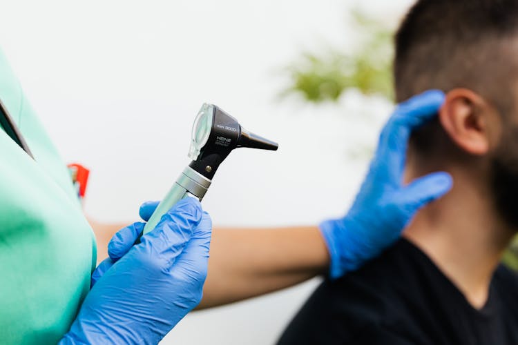 A Person Holding Heine Otoscope