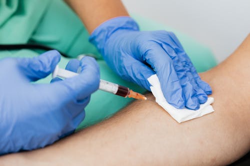 A Medical Professional Extracting Blood from a Patient