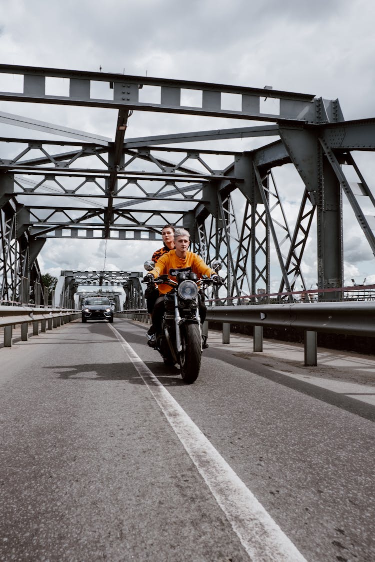 Man With A Woman Riding A Motorcycle