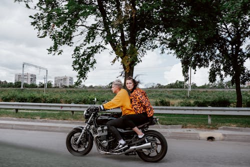 A Man and Woman Riding a Motorcycle Together 