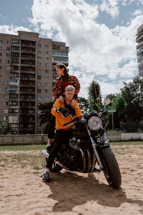 A Man and a Woman Riding a Motorcycle