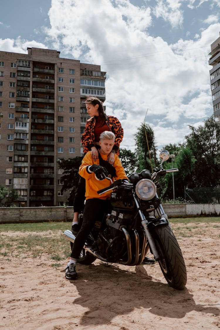 A Man And A Woman Riding A Motorcycle