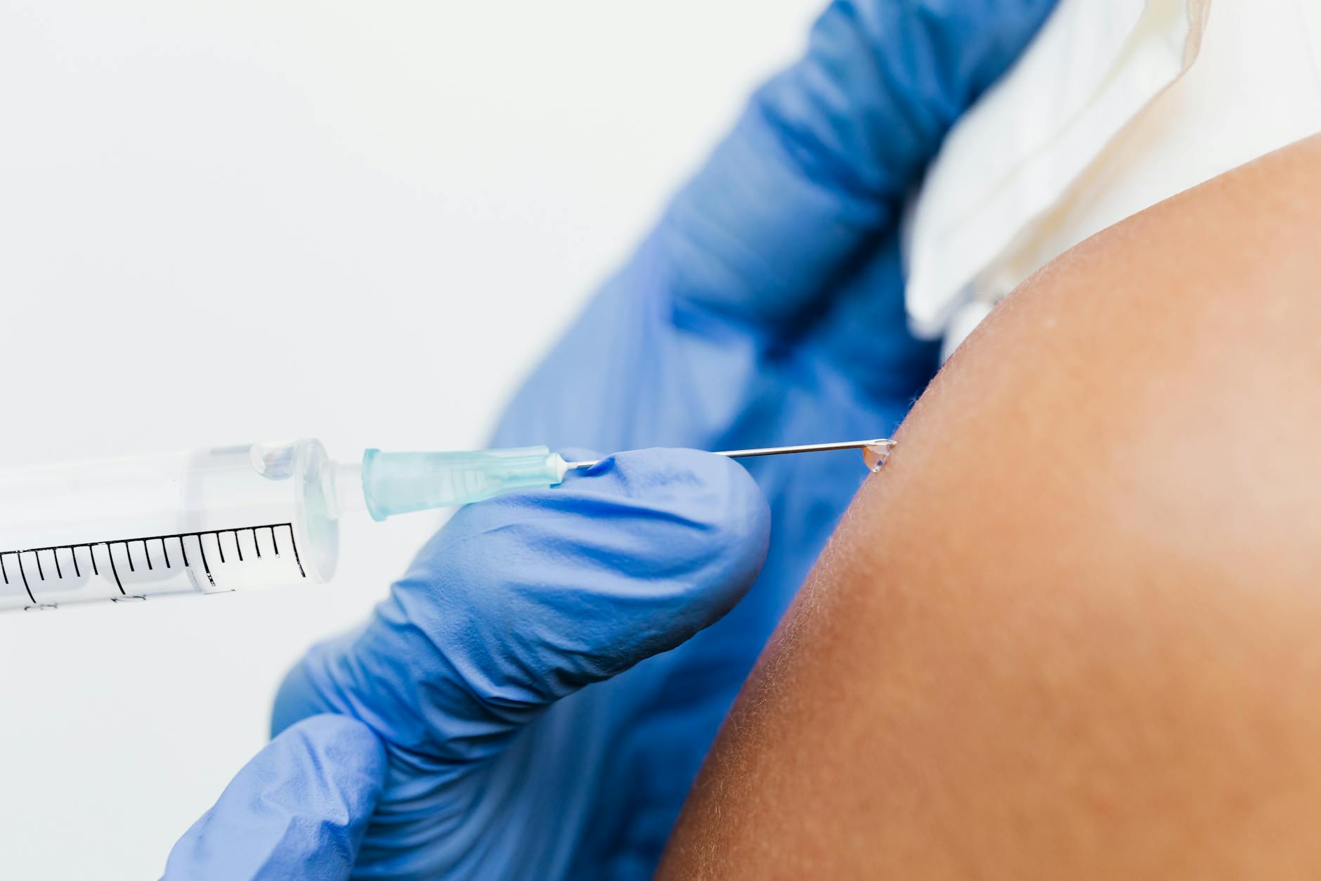 https://www.pexels.com/photo/close-up-shot-of-an-injecting-vaccine-5207018/