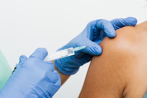 Free Injection on the Arm of a Person Stock Photo