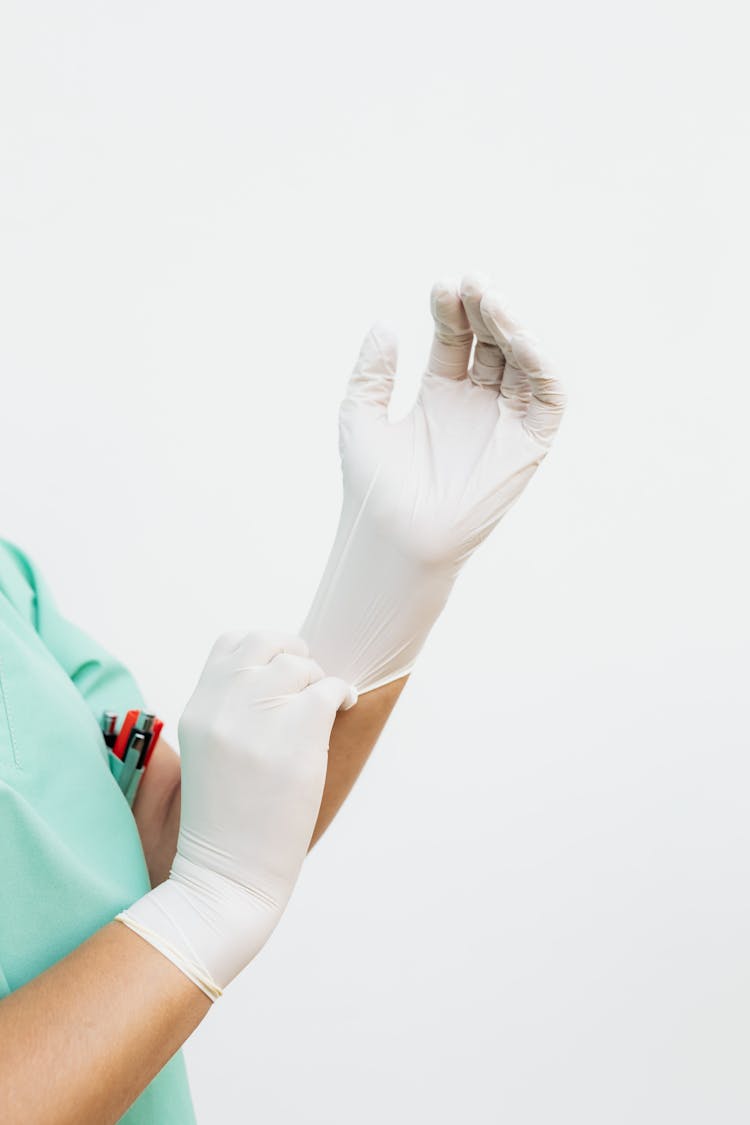 Person Wearing A White Surgical Gloves