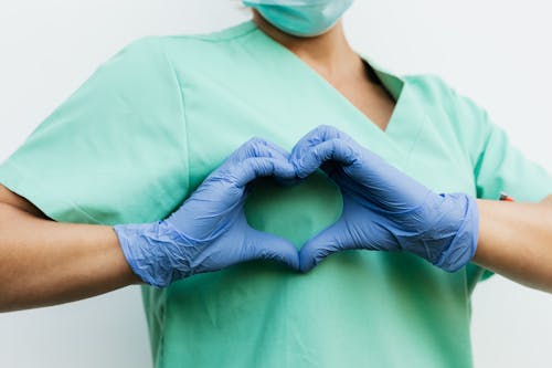 Woman in Green Scrub Shirt With Blue Face Mask