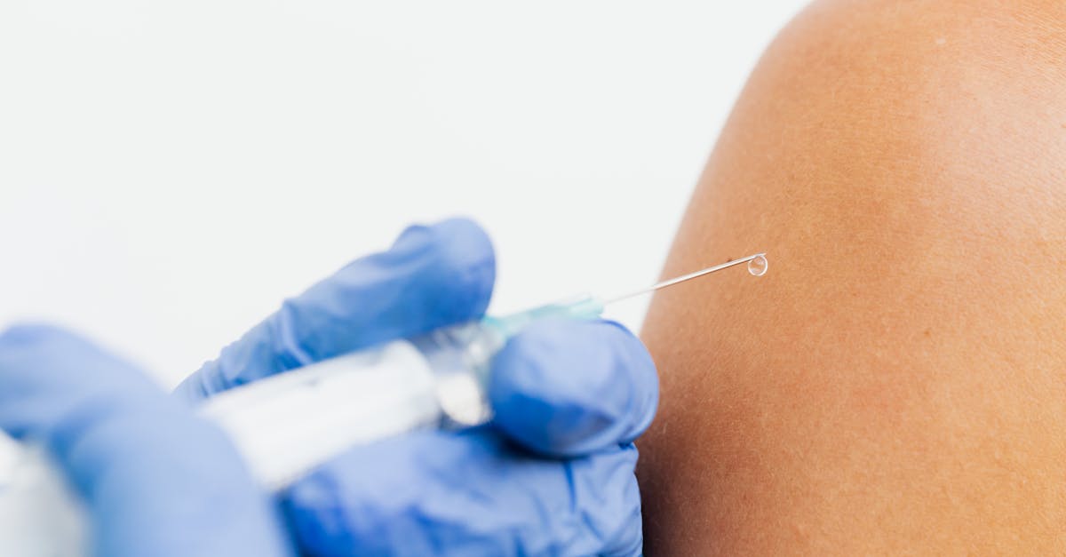 Person Holding an Injection · Free Stock Photo
