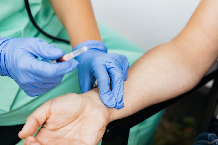 A Person Checking The Pulse