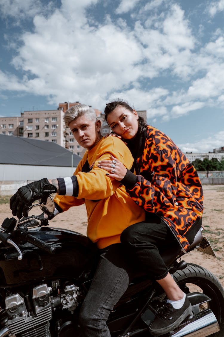 A Couple Riding A Motorcycle