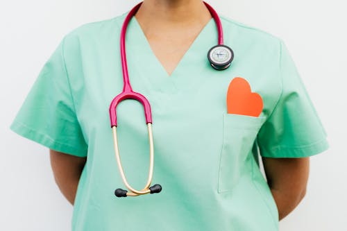 Free A Stethoscope Hanging on Medical Professional's Neck Wearing a Green Uniform  Stock Photo