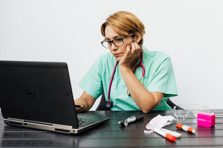 Woman Wearing Eyeglasses While Using Her Laptop