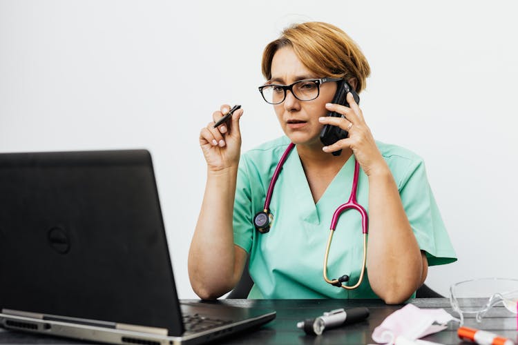 Portrait Of Doctor With Stethoscope Working On Laptop