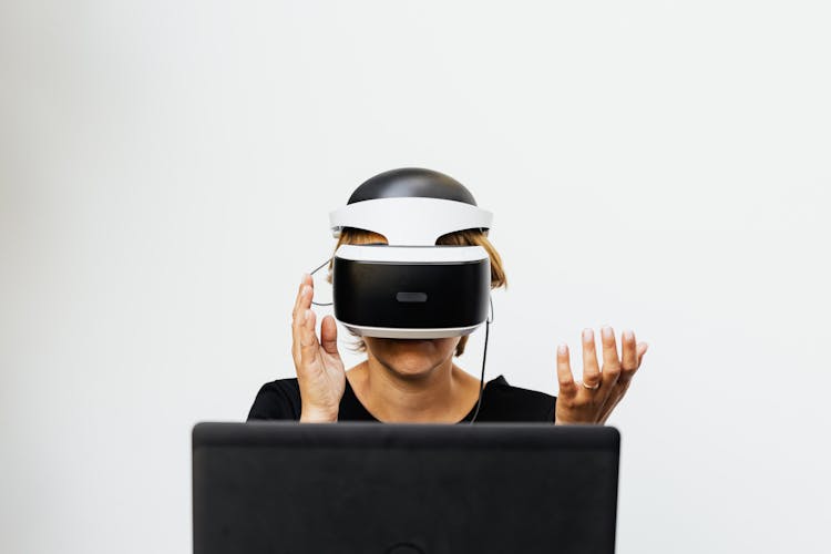 Person Wearing Virtual Reality Glasses In Front Of A Computer