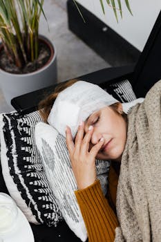 A woman with a head injury rests indoors, showcasing the warmth of a cozy, home environment.