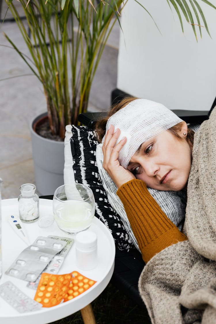 A Woman With Head Bandage Feeling Sick