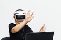 Person in Black Crew Neck T-Shirt Wearing Vr Headset Wearing