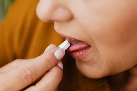 Close-up image of a woman taking a pill, emphasizing health and medication.