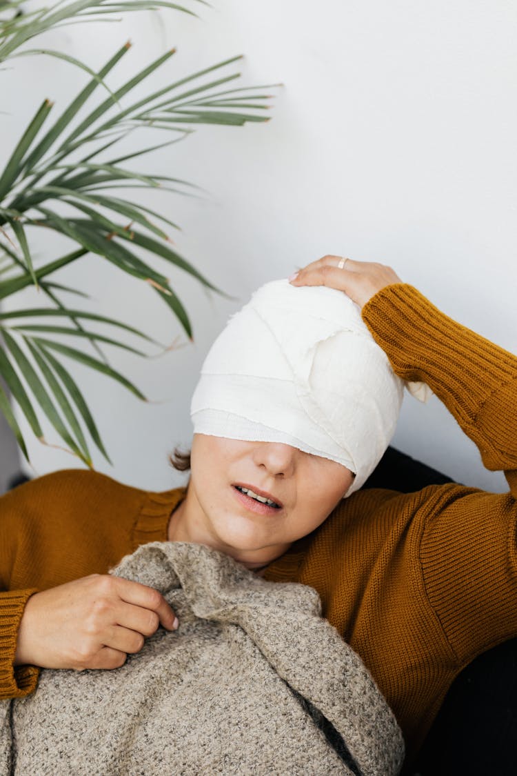 A Woman With A Bandage On Her Head