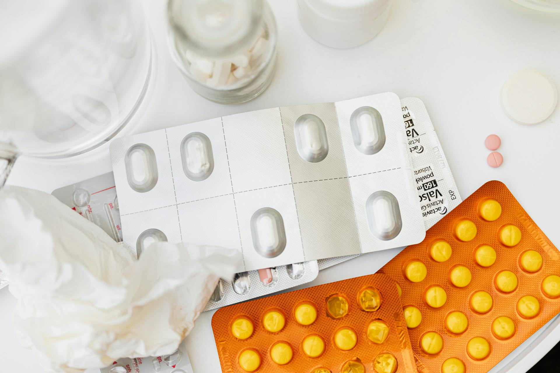 Blister Packs of Assorted Medicines on White Surface
