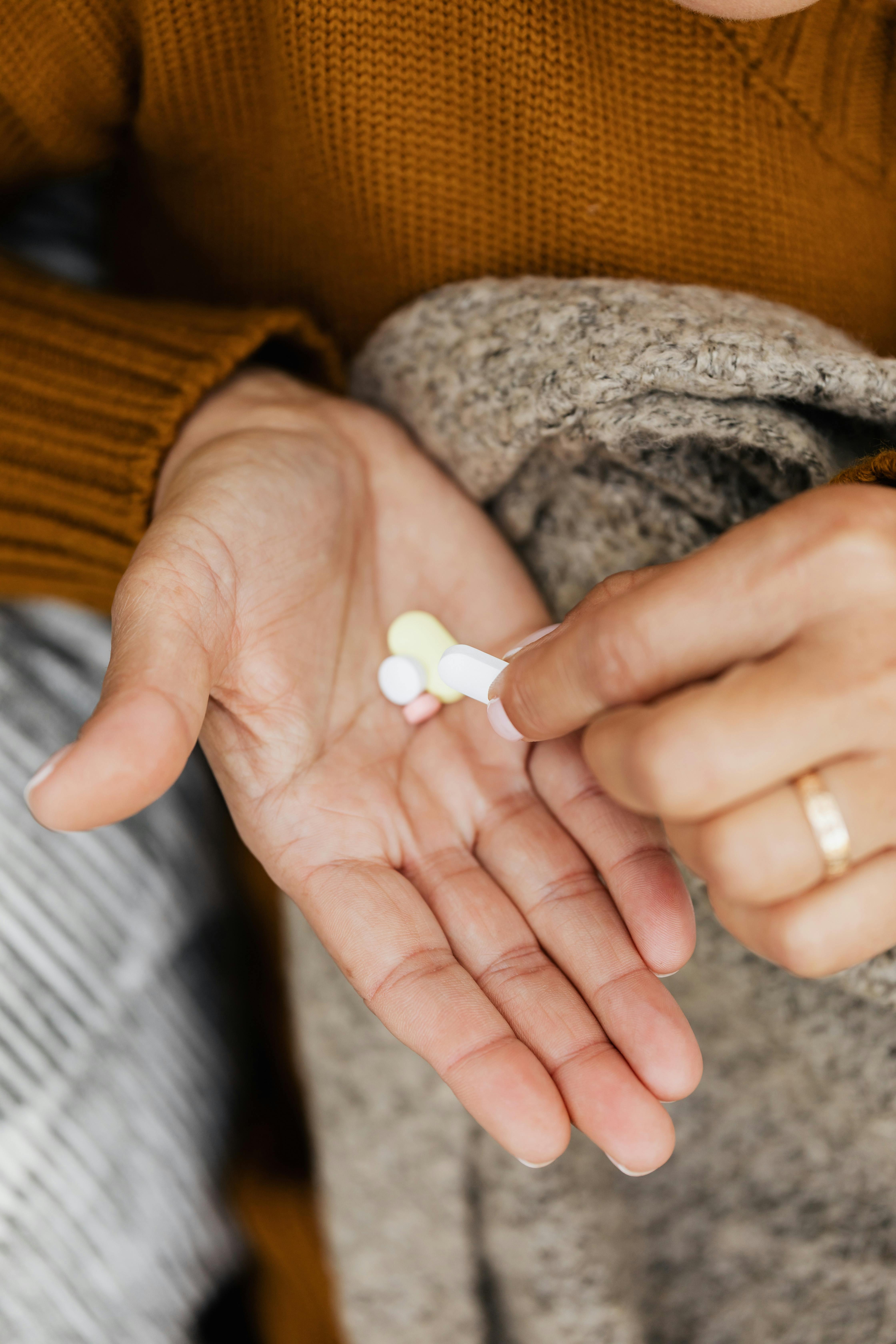 A Close-Up Shot of a Person with Medication on Her Hand