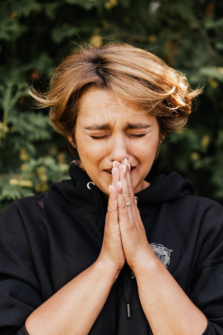 Close-up Photo Of Desperate Praying Woman 