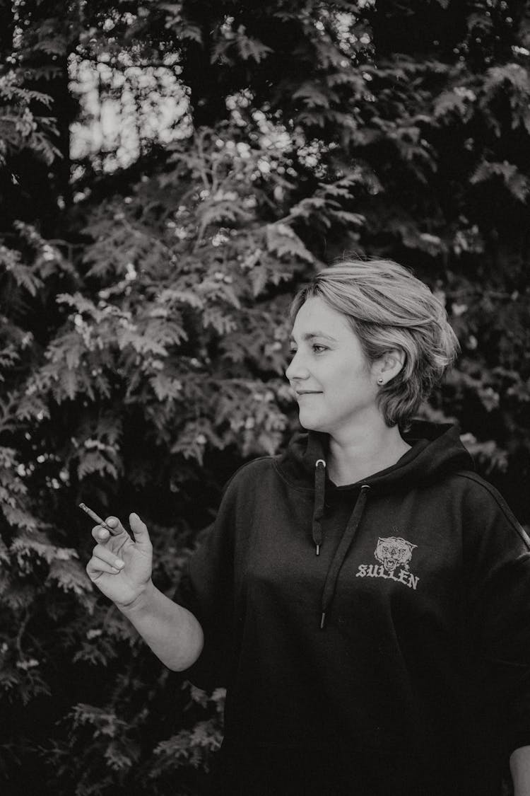 Grayscale Photo Of Woman Holding A Cigarillo