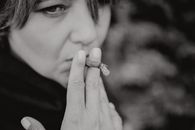 Grayscale Photo of Woman Smoking  Cigarillo