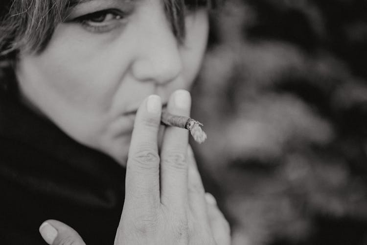 Grayscale Photo Of Woman Smoking  Cigarillo