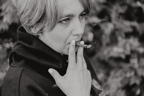 A Grayscale of a Woman Smoking