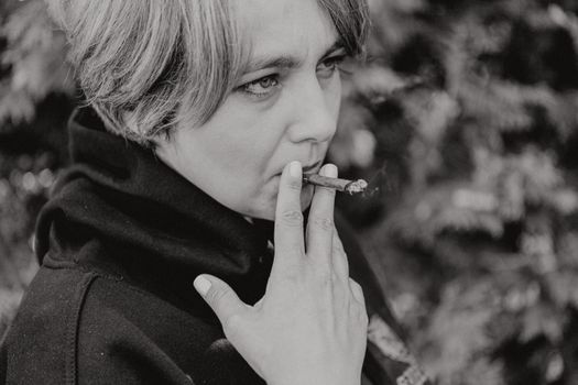 A Grayscale of a Woman Smoking