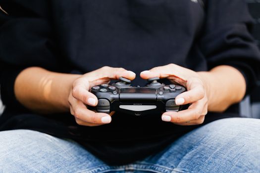 A close-up image of hands holding a video game controller, showcasing leisure and gaming moments.