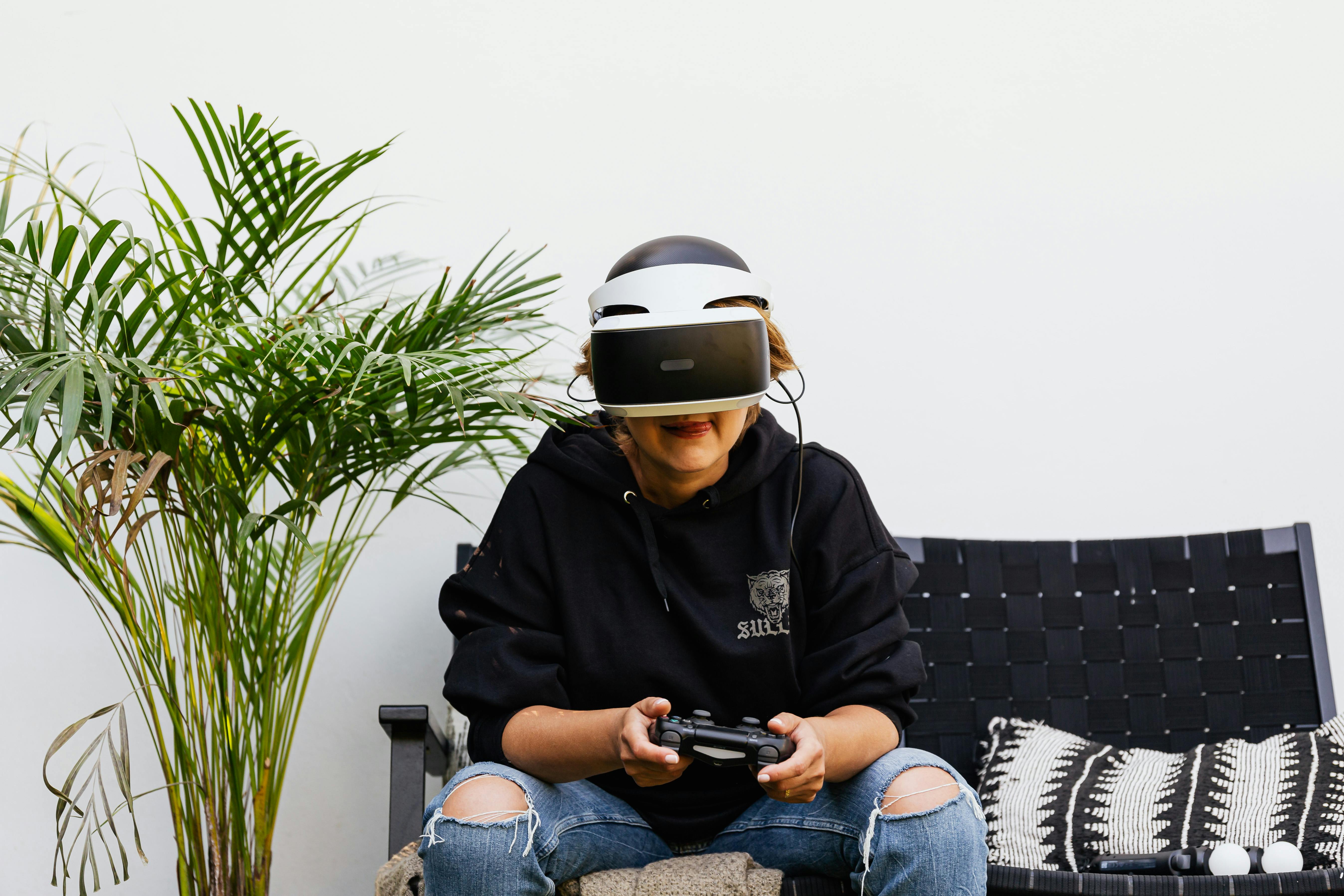 a woman using a vr headset and a game controller