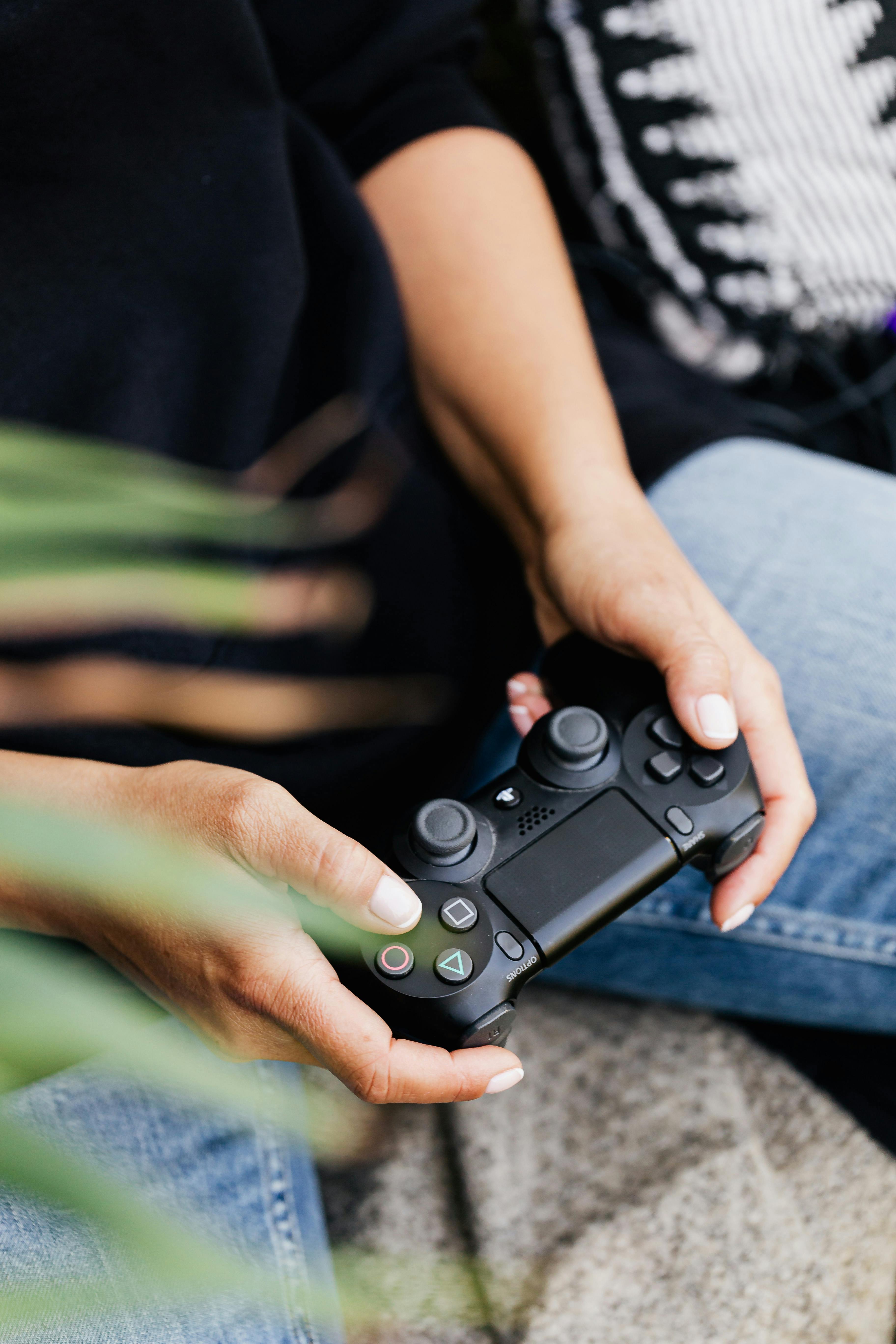 a close up shot of a person using a video game controller