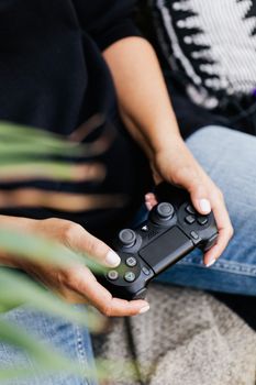 Close-up view of hands holding a gaming controller, highlighting leisure and technology.