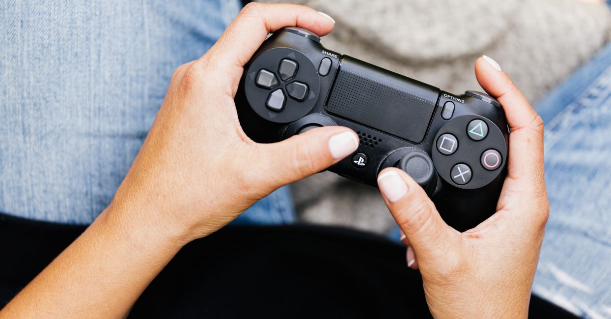 A Close-Up Shot of a Person Using a Video Game Controller · Free Stock ...