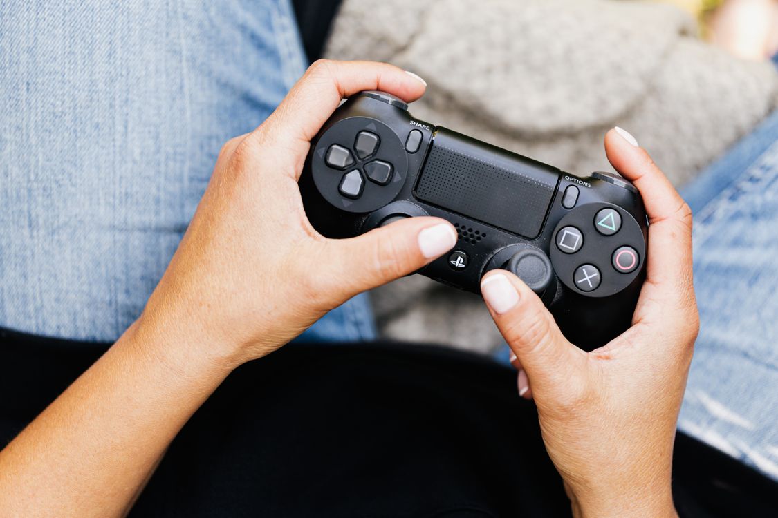 Free Person holding a video game controller, ideal for leisure and gaming themes. Stock Photo